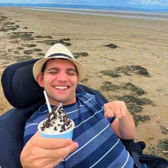 Guest enjoying Ice-Cream on wheelchair accessible beach with Free-Ability Holidays